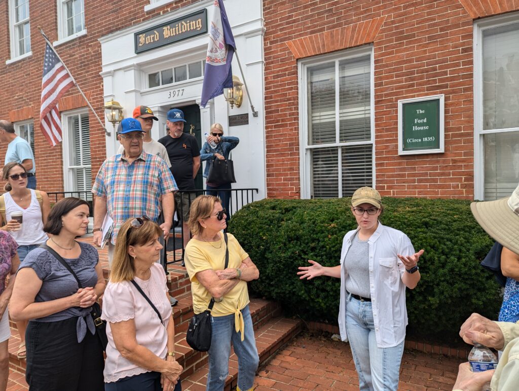 Group of people standing in front of a brick building