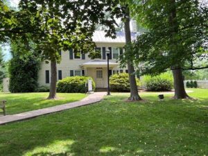 white house with grass and trees